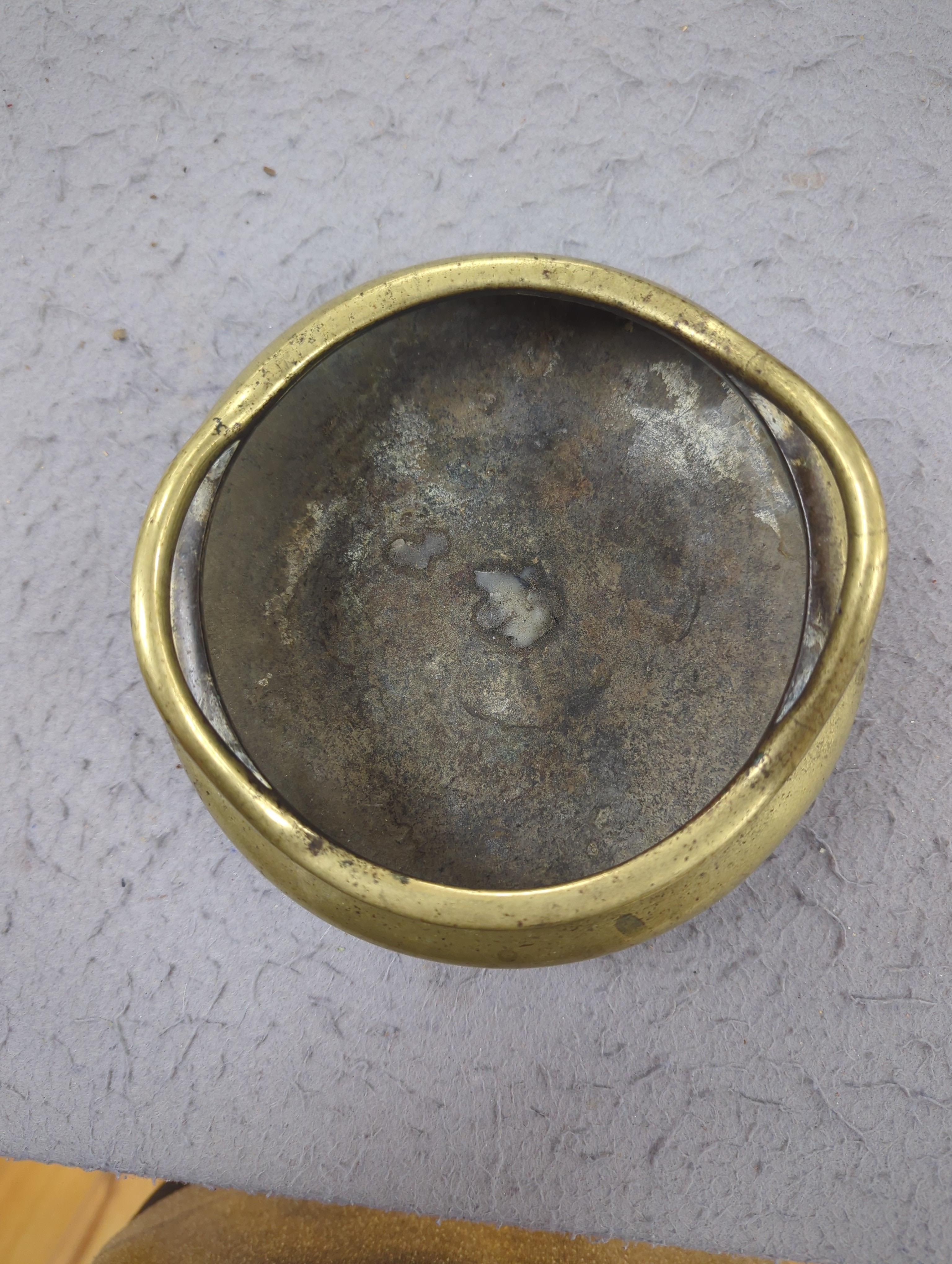 A late 19th century Chinese bronze censer with twin handles, apocryphal Xuande mark, 17.5cm in diameter